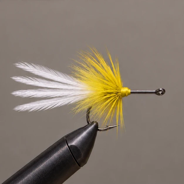 Yellow hackle collar and thread head behind the exposed shank.