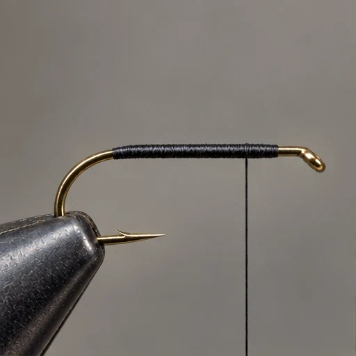 Royal Wulff, step 1: Black thread foundation only; front eye remains clear.