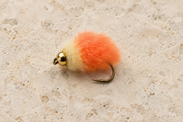 Orange-and-cream Y2K egg fly with a gold bead