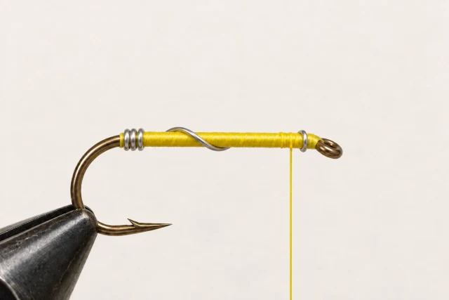 Three rear wire turns and one front turn on a yellow-threaded hook; no body or legs.