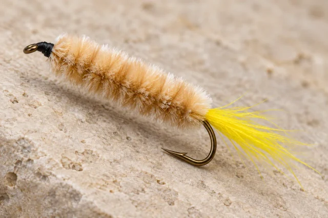 Maple Syrup fly with beige chenille body and yellow calf-tail tail